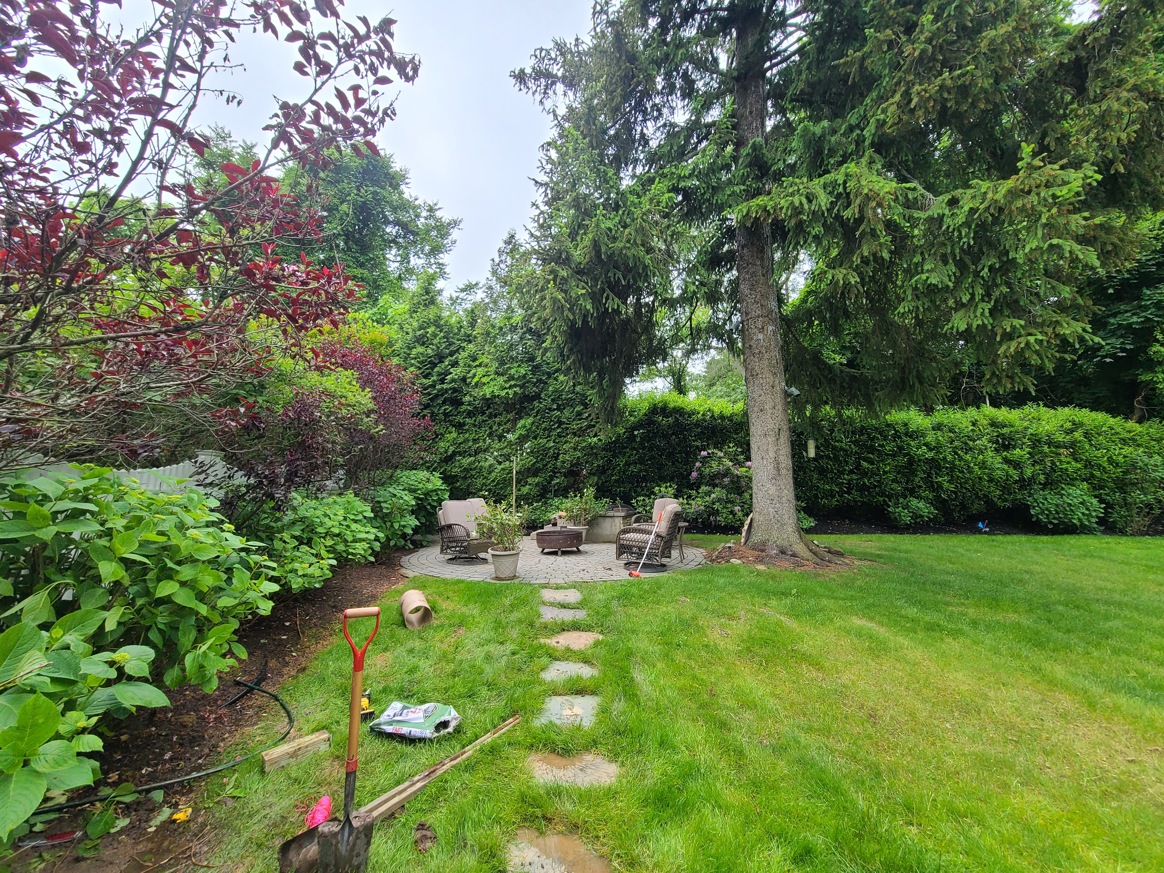Before bistro lighting installation in Huntington backyard